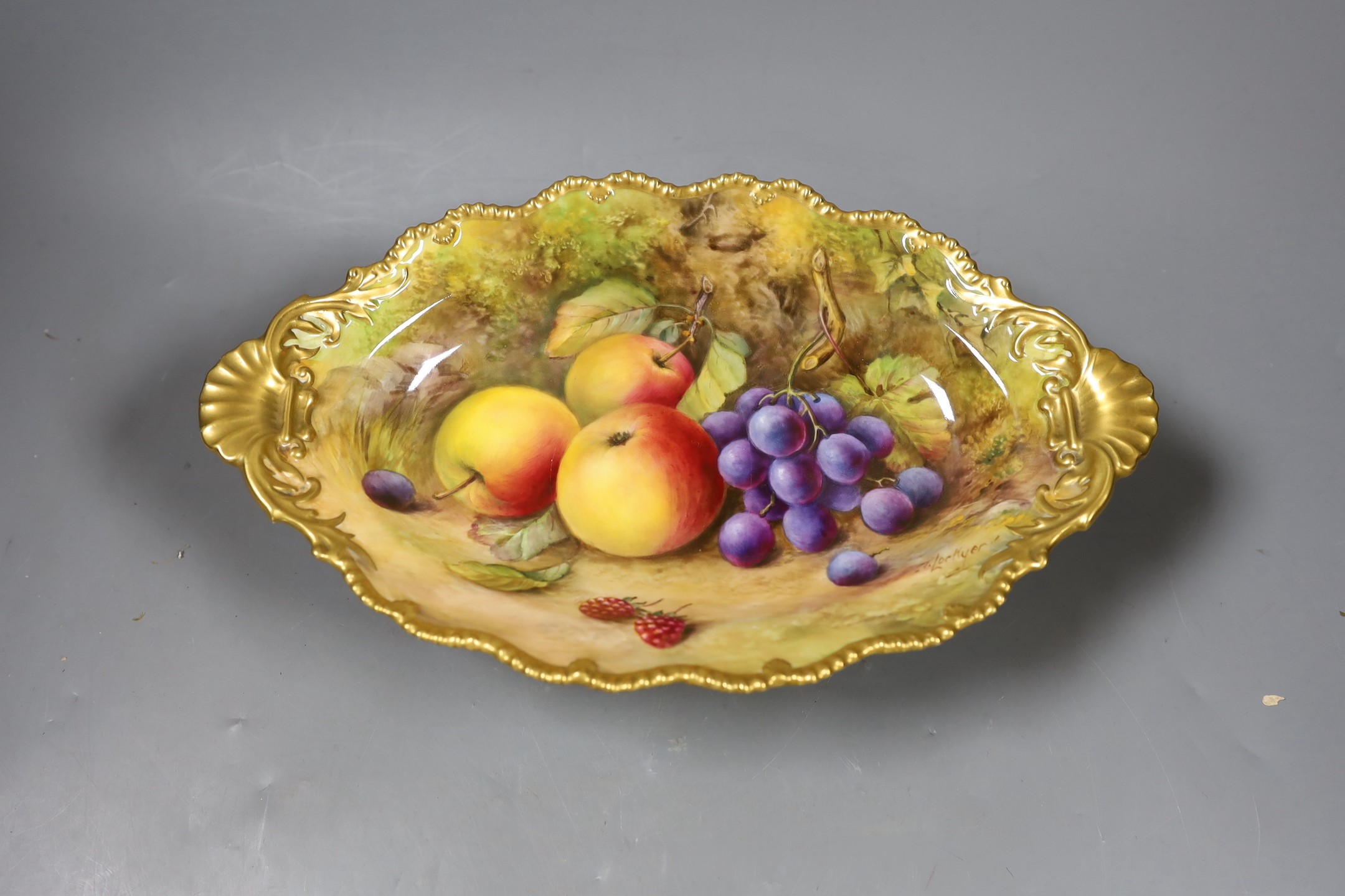 A Royal Worcester fruit painted footed dish, c. 1930, by T. Lockyer. 32cm wide